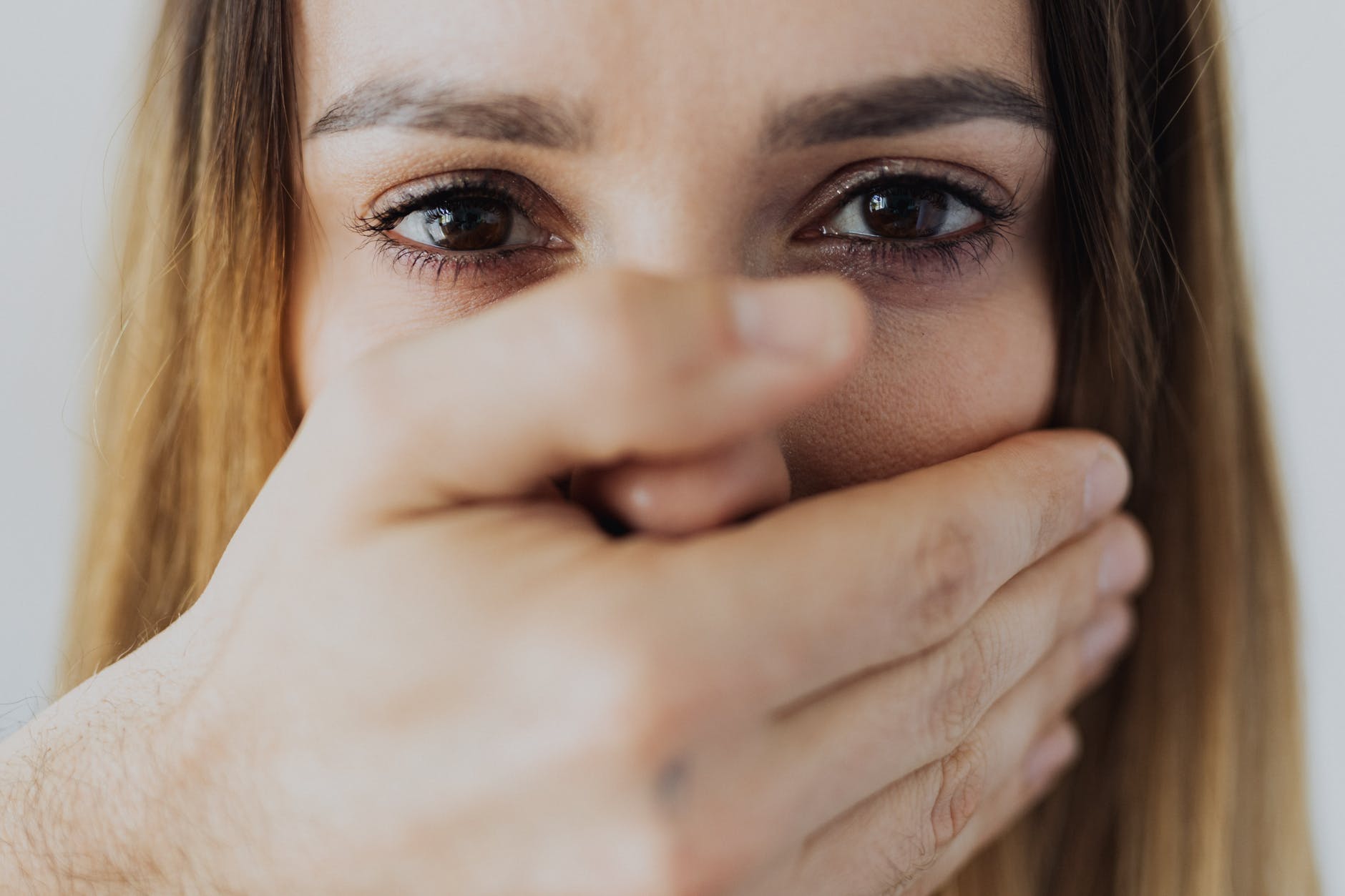 woman covering her face with her hand