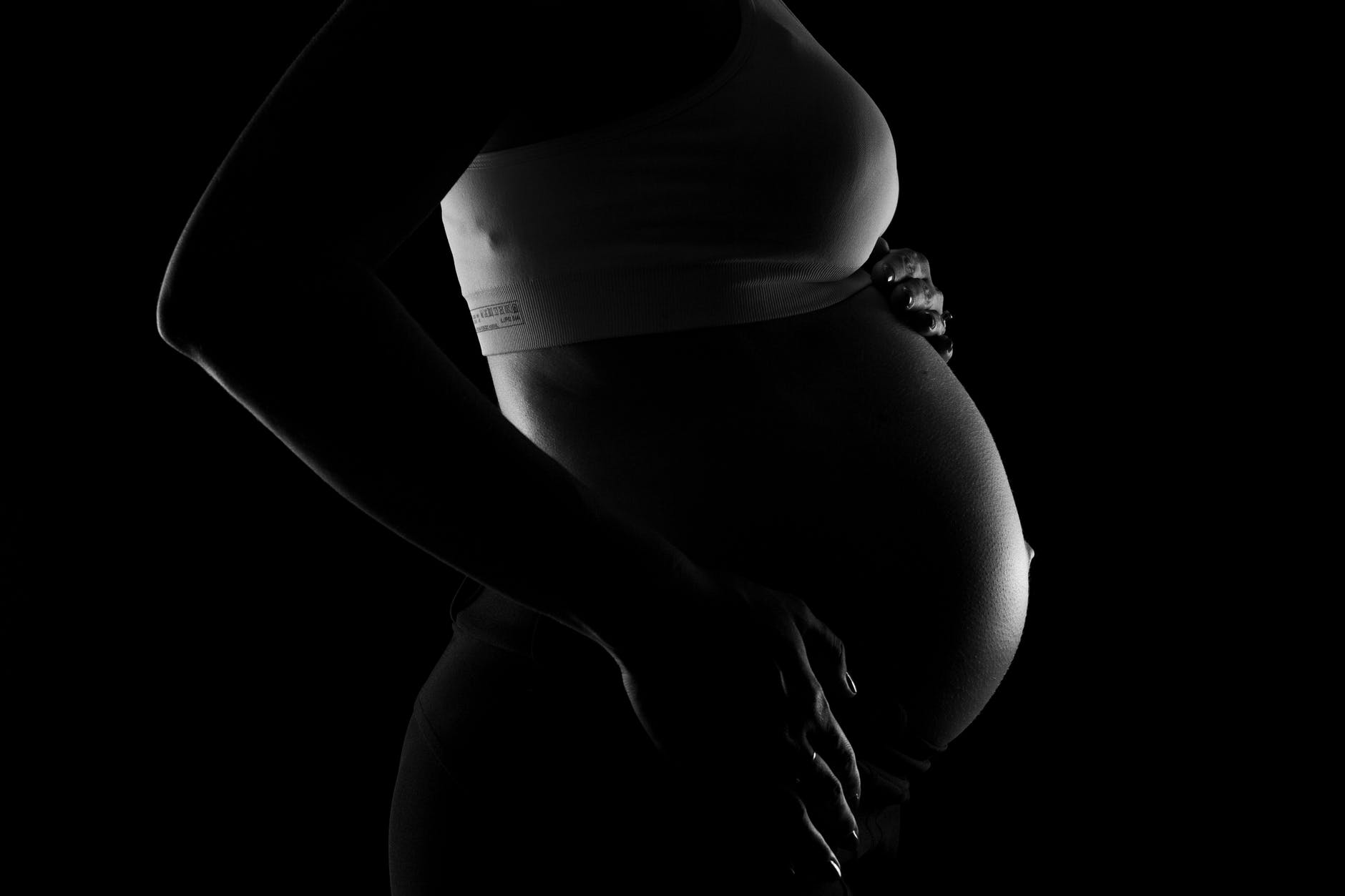 gray scale photo of a pregnant woman